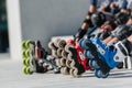 Feet of rollerbladers wearing inline roller skates sitting in outdoor skate park, Close up view of wheels befor skating