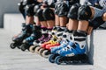 Feet of rollerbladers wearing inline roller skates sitting in outdoor skate park, Close up view of wheels befor skating Royalty Free Stock Photo