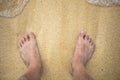 Feet on sea sand with bubble float wave Royalty Free Stock Photo