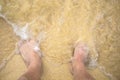 Feet on sea sand with bubble float wave Royalty Free Stock Photo