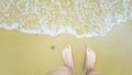 Feet on sea sand and wave with copy space, Vacation on ocean beach, Summer holiday Royalty Free Stock Photo