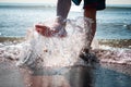 feet splashing water on the sea shore Royalty Free Stock Photo