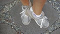 Feet showing grey walking sneakers