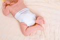 Feet of a six months old baby wearing diapers Royalty Free Stock Photo