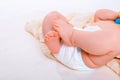 Feet of a six months old baby wearing diapers Royalty Free Stock Photo