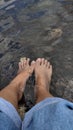 feet slightly submerged in the water