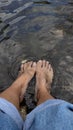 feet slightly submerged in the water