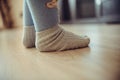 Children`s feet in socks are on the floor Royalty Free Stock Photo