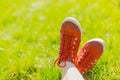 Feet in sneakers on green grass Royalty Free Stock Photo
