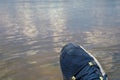 Feet in sneakers over water