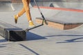 Feet in sneakers of teenager jumping a kick scooter at a skate park. Street culture of young