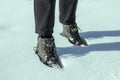 Feet in the snow. Women`s feet in boots stand in the snow.