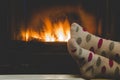 Feet in socks of all the family warming by cozy fire