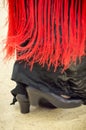 Feet of Spanish Flamenco dancer wearing red Manton Royalty Free Stock Photo