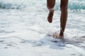 Feet splashing against sea waves on the beach - Summer fun concept background with copy space - Sea & beach vacation traveling con