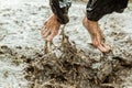 Feet splashing in muddy water Royalty Free Stock Photo