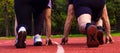 Feet in sports shoes at the start ready to run. People stand in a rack ready to start the race. A sprint race is being Royalty Free Stock Photo