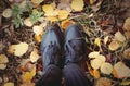 Feet standing on Autumn leaves.