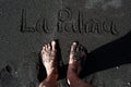 Feet standing on a black sand beach of La Palma Royalty Free Stock Photo
