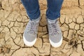 Feet standing on the cracked soil Royalty Free Stock Photo