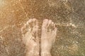 Feet stay on beach sand and water Royalty Free Stock Photo