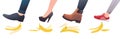 Feet step on banana peel. People slip up on fruit peelings. Organic garbage. Boots and shoes slipping on husks. Misstep