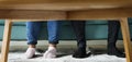 Feet sticking out under a sofa table