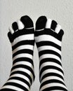 Feet in stockings black and white striped Royalty Free Stock Photo