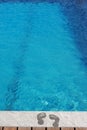 Feet by the swimming pool Royalty Free Stock Photo