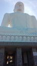 60 feet tall white Buddha statue. Situated on a rock. Royalty Free Stock Photo