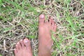 Feet to on the grass.