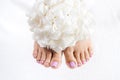 Feet and toenails after pedicure with flowers