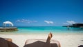 Feet tourist relax at Maldives turquoise sea white sand tropical beach paeadise Royalty Free Stock Photo