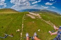 Feet of tourists riding cable car over mountain landscapes