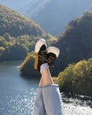 Feet of traveler girl in sneakers on background of mountain lake. Travel, vacation, nature getaway. Rhodope, Bulgaria Royalty Free Stock Photo