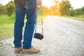 Feet Traveler man and retro photo camera outdoor Travel Lifestyle vacations and travel concept vintage tone Royalty Free Stock Photo