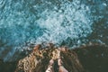 Feet traveler standing at the edge above sea full of Jellyfish in water Royalty Free Stock Photo