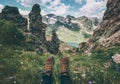 Feet trekking boots and mountains landscape on background Travel Lifestyle adventure