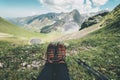 Feet trekking boots and mountains landscape on background Travel Lifestyle adventure