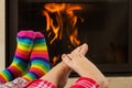 Feet warming by fireplace
