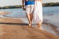 Feet in the water summer. Young barefoot couple walking along the beach. Love story. Waves and sand. Concept of rest. Royalty Free Stock Photo