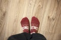 Feet wearing Christmas socks on wood floor. Happy family at home. Xmas holidays concept Royalty Free Stock Photo