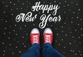 Feet wearing red shoes on black background with Happy New Year Royalty Free Stock Photo