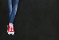 Feet wearing red shoes on black background Royalty Free Stock Photo