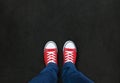 Feet wearing red shoes on black background Royalty Free Stock Photo