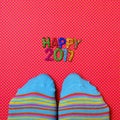 Feet wearing socks and text happy 2017