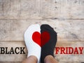 Feet wearing white and black socks with red heart shape Royalty Free Stock Photo