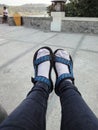 feet wearing white socks and blue black sandals Royalty Free Stock Photo