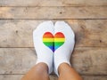 Feet wearing white socks with LGBT pride color heart shape Royalty Free Stock Photo