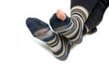 The feet with well worn striped socks isolated on a white background. Royalty Free Stock Photo